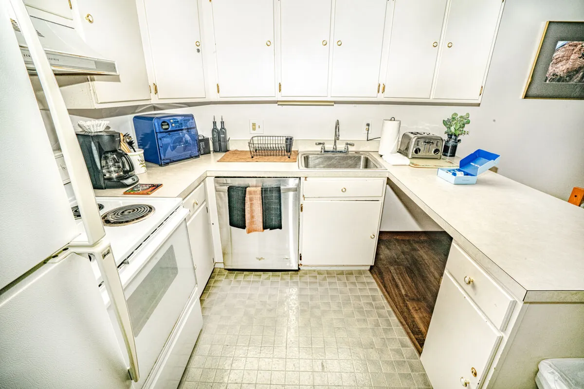 A well-equipped, modern kitchen with sleek appliances, a spacious countertop, and inviting cabinetry. The area is bright and airy, hinting at the possibility of preparing picnic snacks or meals after a day enjoying the outdoors.
